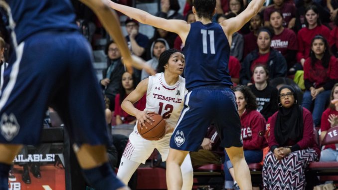 Freshman guard Emani Mayo (center) looks for an open teammate while marked by UConn senior guard Kia Nurse in the Owls’ 113-57 loss on Sunday at McGonigle Hall. | SYDNEY SCHAEFER / THE TEMPLE NEWS