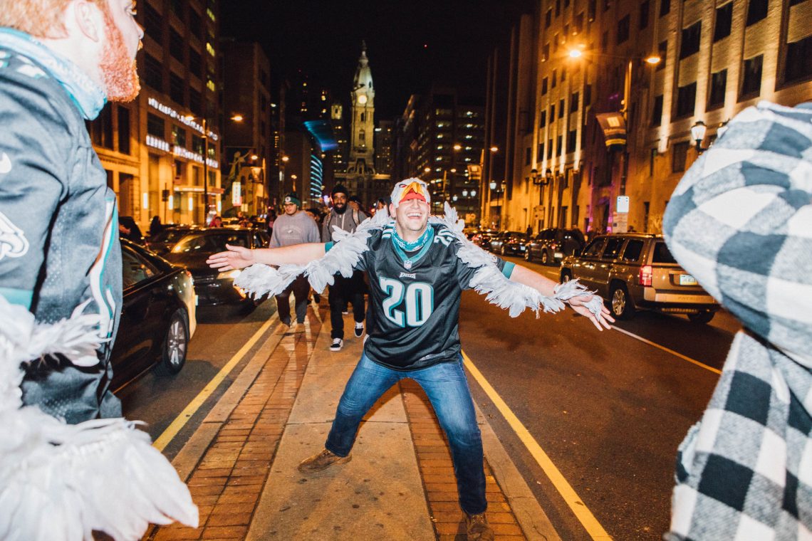 An Eagles fan celebrates on the median of Broad Street, flapping his arms like wings, after the Eagles won the NFC Championship to advance to the Super Bowl on Sunday. | SYDNEY SCHAEFER / THE TEMPLE NEWS