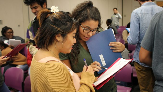 Peer mentors Natalie Abellanosa (left) and Julia Ostrovsky participate in a scavenger hunt at a peer mentorship event in September. | CHYNNA CUMMINGS /FILE PHOTO