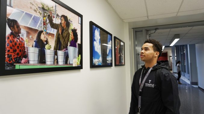 Freshman neuroscience major Daniel Gilliam looks at photographs of former First Lady Michelle Obama in Paley Library. The photos were taken by Amanda Lucidon and are on display until Jan. 22. | CACIE ROSARIO / THE TEMPLE NEWS