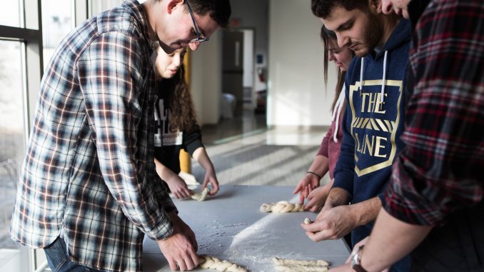 Members of Temple’s Challah for Hunger chapter braid challah dough in the Hillel at Temple University on Norris Street near 15th on Thursday. | SYDNEY SCHAEFER / THE TEMPLE NEWS