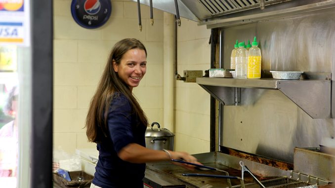 Chef Christina Wilson stands inside Ali’s Middle East Food located in the 12th Street Food Pad Vendors. Wilson returns to the stand occasionally to enjoy the food she loved during her time at Temple. ( PAUL KLEIN / TTN )