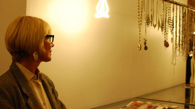 A jewelry designer looks at her collection in Knit Wit Boutique during Fashion’s Night Out on Sept. 6. ( MARISSA PINA / TTN )