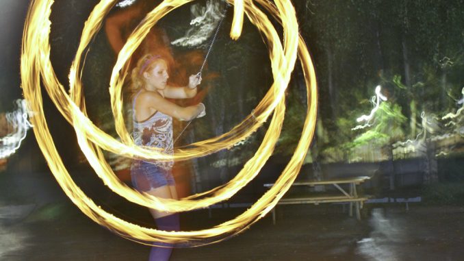 Nadine Thomas performs poi with fire. Thomas hopes to start Temple Flow Arts, a student organization for poi. ( JESSICA REPKO // TTN )