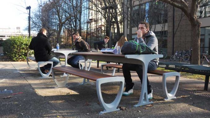 Senior advertising major Mike Negri, 23, eats at the new picnic tables. | ABI REIMOLD / TTN