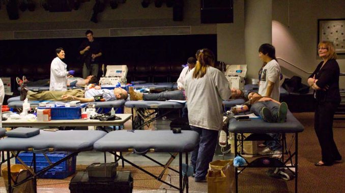 Donors lie down on a table while getting their blood drawn at Keep the Drive Alive on Nov. 21. | LUIS FERNANDO RODRIGUEZ / TTN