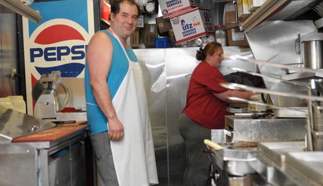 Bill and Sylvia Ndreu work on the Five Dollar Foot Long Truck on 12th Street. They reported no damage as a result of Hurricane Sandy last week. | ABI REIMOLD / TTN