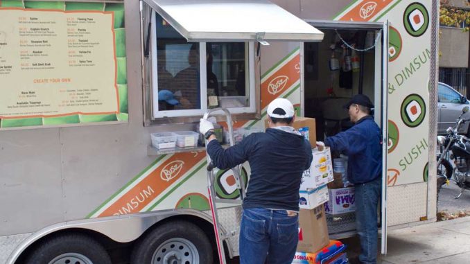 Busz Sushi & Dim Sum receives an order of supplies. The newly opened lunch truck is located on the 1300 block of Norris Street. | LUIS FERNANDO RODRIGUEZ / TTN