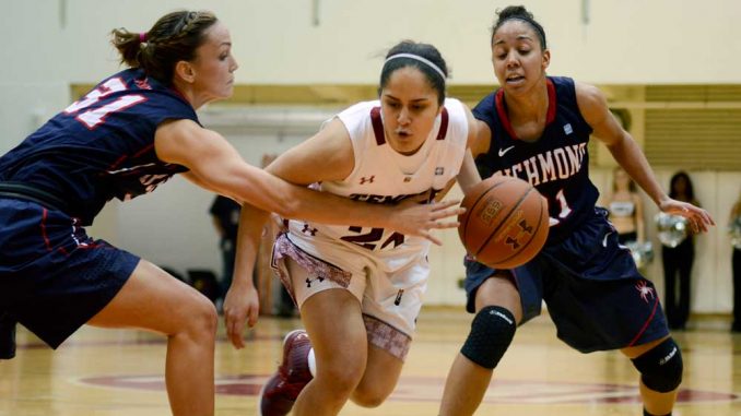 Freshman guard May Dayan (center) drives the lane in a 61-48 win against Richmond on Jan. 31. Dayan is one of five freshmen to receive playing time this season. | MAGGIE TRAPANI / TTN