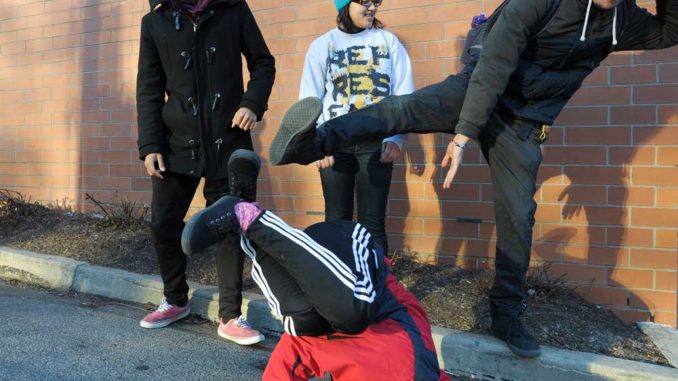 Danzel Thompson-Stout, Bea Martin and Cristian Barreto watch Neha Sharma breakdance outside the TECH Center. | ABI REIMOLD / TTN