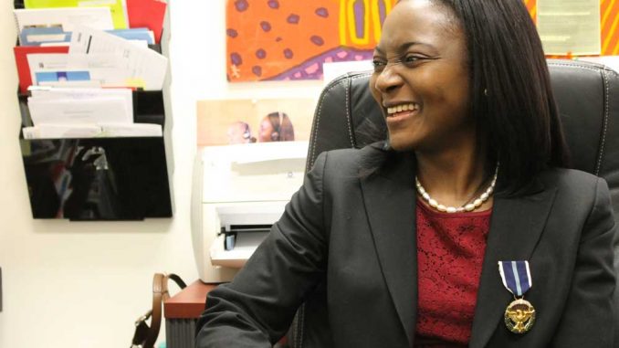 Patience Lehrman wears her Presidential Citizens Medal in her office. | ALI WATKINS / TTN