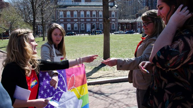 Members of Philly Supports Liberty hand out LGBT rights stickers. | LAURA ORDONEZ / TTN