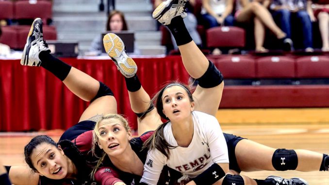 Senior Gabriella Matautia (left) dives to the floor alongside her teammates during competition at the Temple Invitational. | Hua Zong TTN