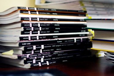 Jennifer Orlet Fisher, PhD, shows years of research with magazines stacked high at the Center for Obesity Research and Education. | Norah Gunn TTN