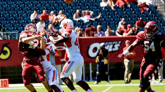 Redshirt-junior quarterback Connor Reilly (left) often found himself with little time to throw the ball, taking numerous hits as he was forced out of the game in the fourth quarter due to injury. | Hua Zong TTN