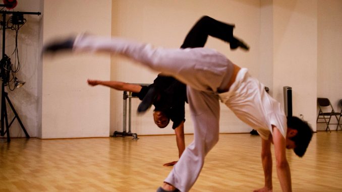 Lin practices with dancer Brian Codoua, showing him the emotion his movements are supposed to impose. Lin believes the body speaks louder than words, and that identity can be found in the way people move. Meaghan Pogue | TTN