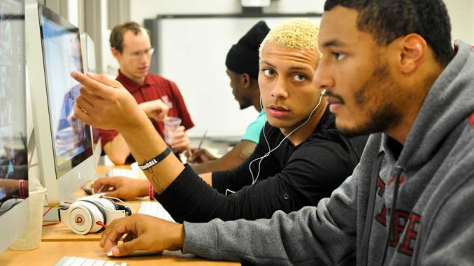 Sophomore Dondi Kirby (center) and freshman Jarrad Alwan, both members of the football team, utilize the Student-Athlete Academic Advising & Support Center. The football team’s APR has steadily increased since 2006-7. | SASH SCHAEFFER TTN