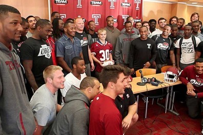 Chris Richer (middle), a 15-year-old boy, was “adopted” by the football team. | COURTESY TEMPLE ATHLETICS