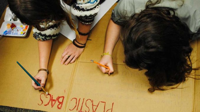 Vice president of SEA Morgan Nemtuda (left) and Bonnie DuPrey work on a poster that will display the negative effects plastic bags have on the environment as part of their new campaign to ban them on campus. Online. | Danielle Hagerty TTN