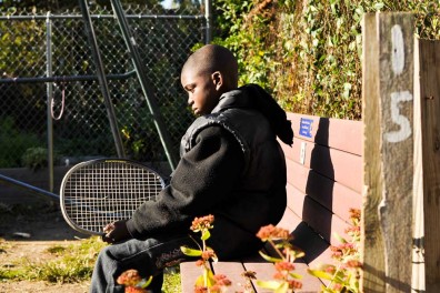 Kevon Lewis sits on a bench in an empty lot-turned garden on West Rockland Street in Germantown. The street is the subject of a community improvement project organized by sisters and street residents Emaleigh and Aine Doley. | JACON COLON TTN