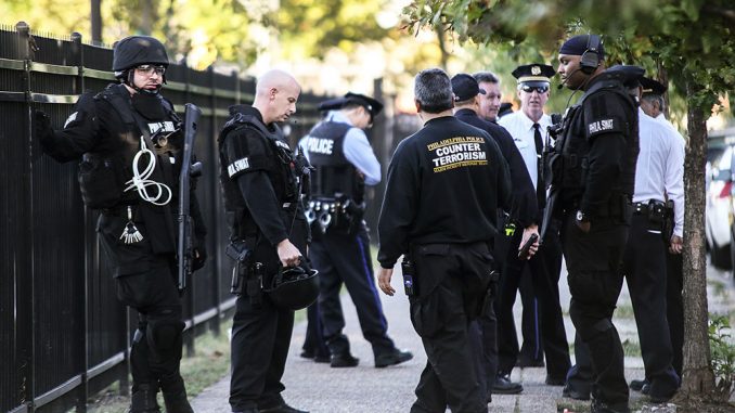 Philadelphia police SWAT and counterterrorism officers gather on Berks Street Sunday, Oct. 13, during the 17-hour standoff between police and an armed student. The standoff ended at 2 a.m. Monday morning with the student detained alive. | Hua Zong TTN