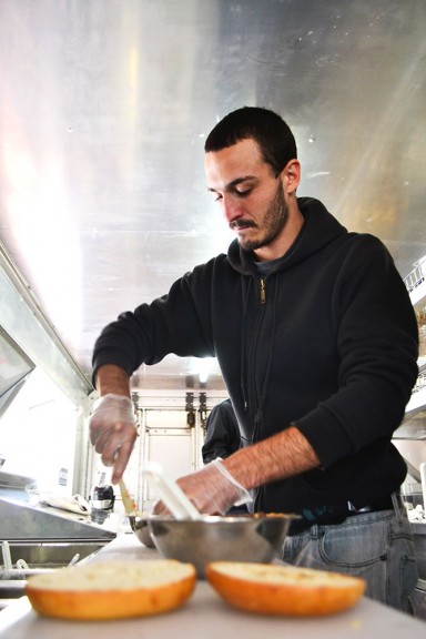 Eddy, an employee at Schmear It, mixes personalized Coldstone-Creamery-style cream cheese for customers. | Skyler Burkhart TTN