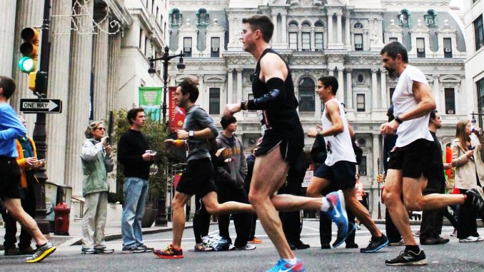 Competitors race by City Hall during the 20th annual Philadelphia Marathon on Sunday, Nov. 17, in which 30,000 participated. | Aja Espinosa TTN