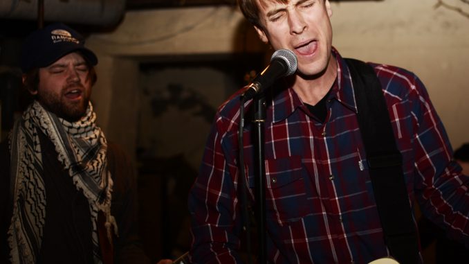 Ryan McCloskey (right), on guitar, vocals and harmonica practices with his band Song Dogs for an upcoming show on Thursday at Underground Arts. | Andrew Thayer TTN