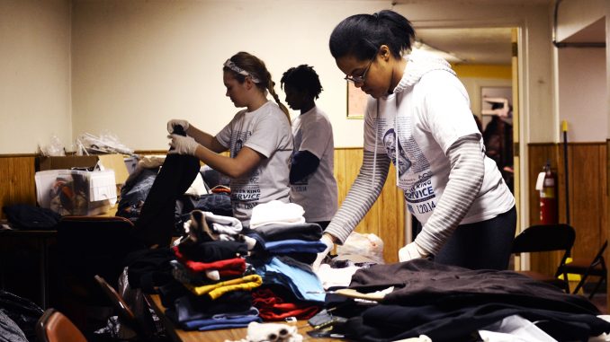 Volunteer Temple student Janice Durant, a junior communication studies major, folds donated clothes at Berean Presbyterian Church on Martin Luther King Jr. Day. | Andrew Thayer TTN