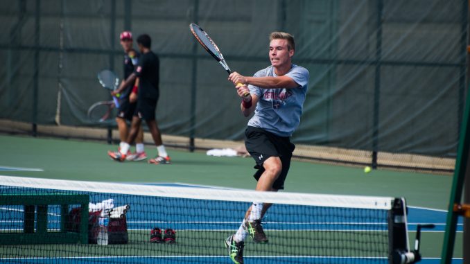 Sophomore Nicolas Paulus hits a ball while competing at the Navy Invitational last September. Paulus collected an 8-5 record during the fall season and led the team in single wins with 15 during the 2012-13 season. | Abi Reimold TTN