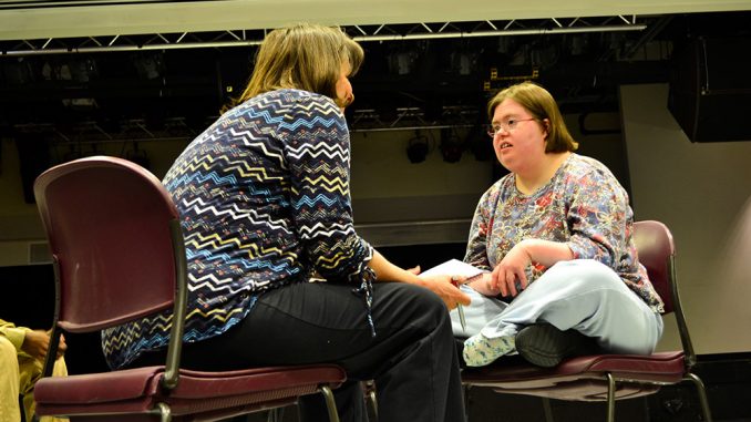 Erin McNulty (right) interacts with another cast member in a play produced by Visionary Voices. | Sergei Blair TTN