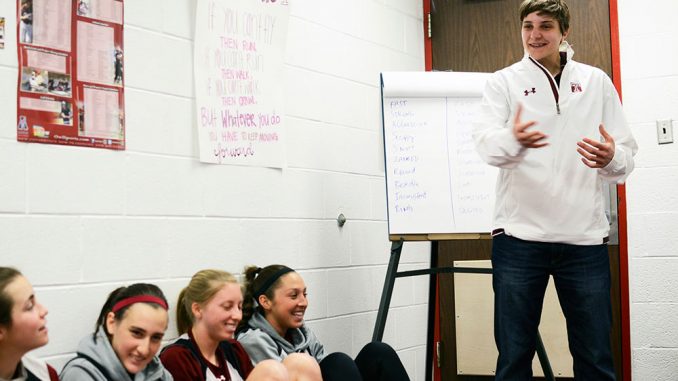 Kat Longshore (right) talks to members of the lacrosse team during one of her sessions with the Owls. Longshore said she meets with the team at least once per week. | Andrew Thayer TTN