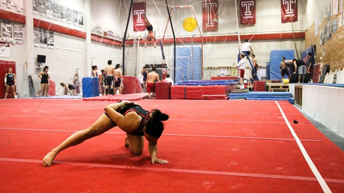 Jasmine Johnson finishes a routine on the mat in McGonigle Hall during a recent practice. | Kelsey Dubinsky TTN