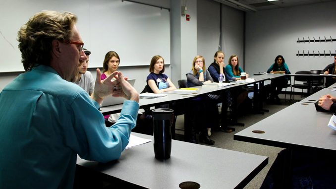 Andrew Karpinski (left) has taught Workings of the Mind for six years. He believes the subject matter of the class can cause some students to feel discomforted because they are asked to question the purpose of their own existence. He advises the use of on-campus counseling services. | Claire Sasko TTN