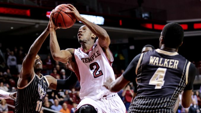 Junior guard Will Cummings (center) drives to the hoop during Temple’s 86-78 overtime win against Central Florida, which improved Temple’s home record to 4-9. The Owls will face the Knights again on Wednesday in the first round of the American Athletic Conference tournament. | HUA ZONG TTN