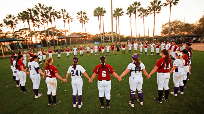 After an 11-3 loss, the Owls and members of Central Arkansas stand in a circle of prayer in recognition of the program being eliminated. | COURTESY BRADLEY WIDDING