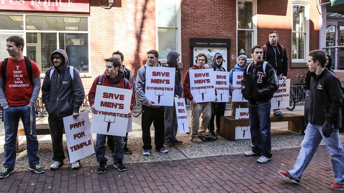 Members of the men’s gymnastics team protest near Liacouras Walk before February’s Board of Trustees meeting that led to the reinstatement of the crew and rowing teams. The program is slated to be eliminated on July 1. | HUA ZONG TTN