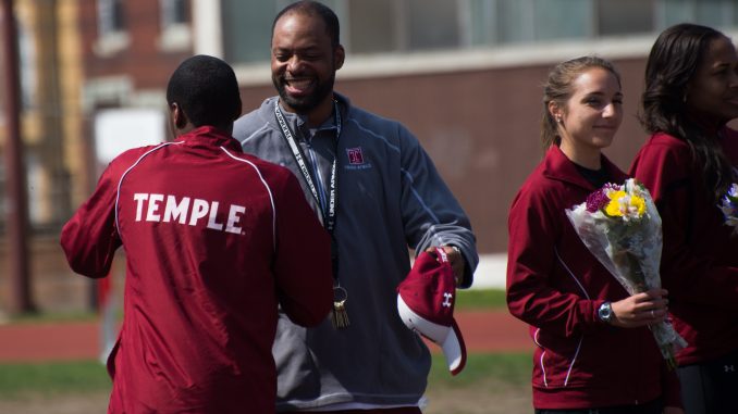 Coach Eric Mobley (center) congratulates senior sprinter Marcus Robertson (left) in a ceremony honoring the seniors of the men's and women's track & field teams. // ABI REIMOLD // TTN