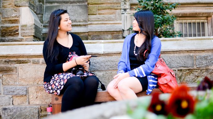 Kaniz Pramanik interviews Professor Marybeth Acac last Thursday after taking her photo for “Humans of Temple University.” She will post the professor’s responses as the caption of her photo on the project’s Facebook page. | Skyler Burkhart TTN