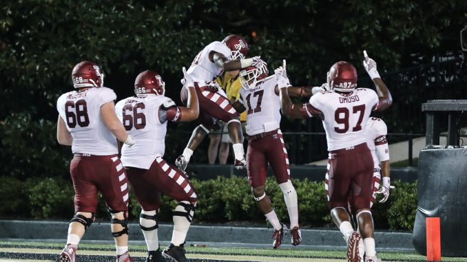 P.J. Walker (center) celebrates with teammates after rushing for a touchdown in the third quarter of Temple's 37-7 win at Vanderbilt Thursday. | Hua Zong TTN