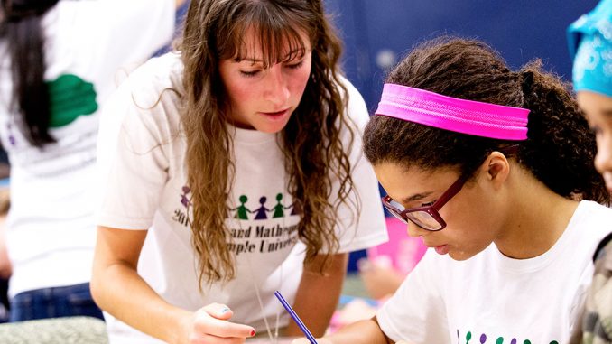 Female Temple students work with girls in grades five through eight to help build their confidence in mathematics. | COURTESY RYAN BRANDENBERG