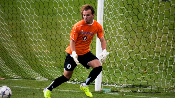 Dan Scheck eyes an errant shot during a game last fall. Scheck, a senior, will return as the team’s starter in net. TTN File Photo