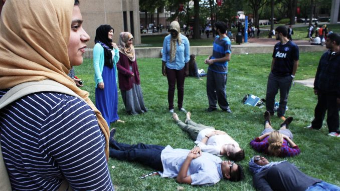 Members of the Muslim Student Association came together to form a human peace sign on Sept. 18. Claire Sasko | TTN