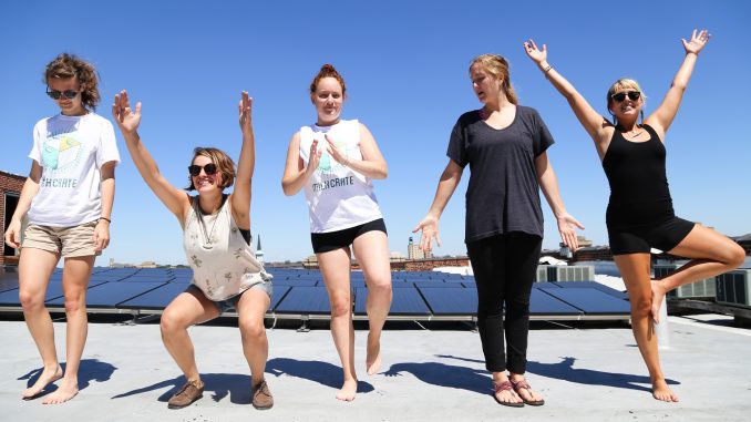 Members of MilkCrate and Solar States practice their yoga moves on the rooftop of the Crane Arts Building in Olde Kensington. Left: Nicole Koedyker, Maddie Allen- Sandoz, Caitlin Honan, Mary Jo Burnham and Ashley Tryba. Andrew Thayer| TTN