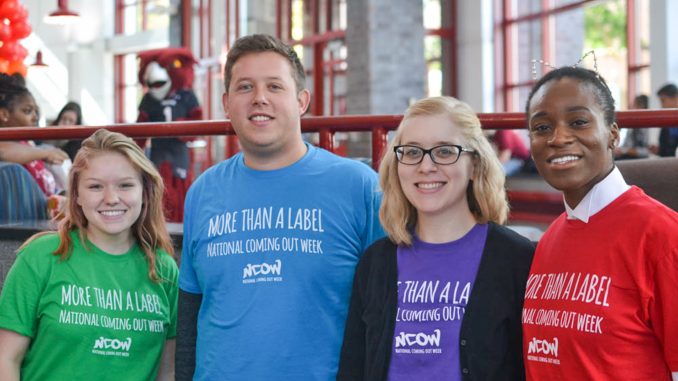 Kristen Welser, Tom Grey, Janie van der Toorn and Safiatou Dagnoko held a booth for the Wellness Resource Center at the university’s National Coming Out Week event on Friday Oct. 17. Jenny Kerrigan | TTN