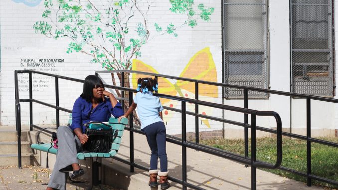 Alana Buckner (top) waits outside of the Tanner Duckrey Elementary School with her daughter. Alisa Miller | TTN