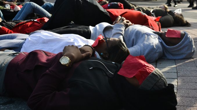 Students lay on Liacouras Walk as part of a "die-in" staged Thursday afternoon. | JENNY KERRIGAN TTN