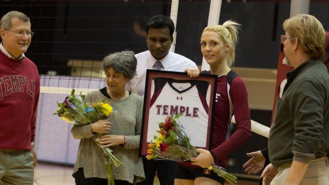 Tiffany Connatser receives flowers and a framed jersey alongside her parents last Friday. Donald Otto | TTN