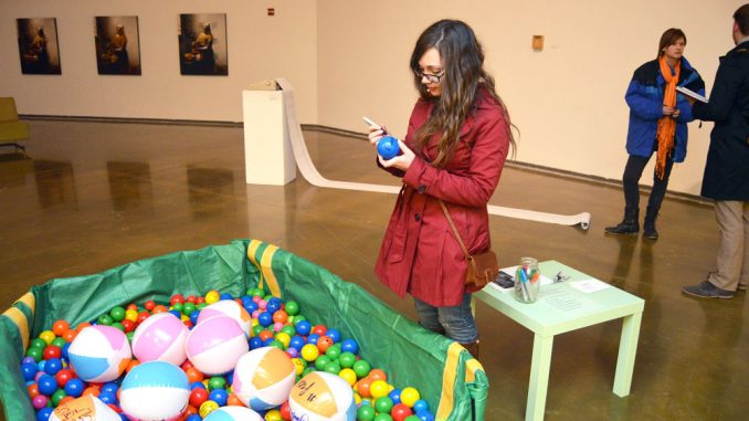 Hannah Pigeon writes her own “weird habit” on a ball as part of an interactive exhibit. Greg Frangipani | TTN