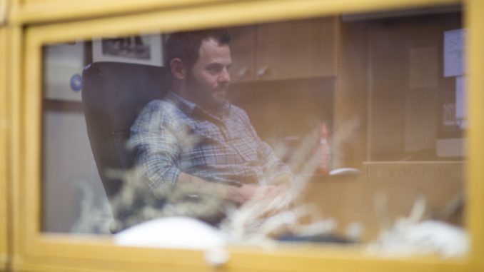 Dr. Erik Cordes is reflected in a case of coral in his office in the Bio-Life building. Cordes and a team of researchers collected coral samples for the tests during a month-long trip on a research ship in 2010. |KARA MILSTEIN TTN